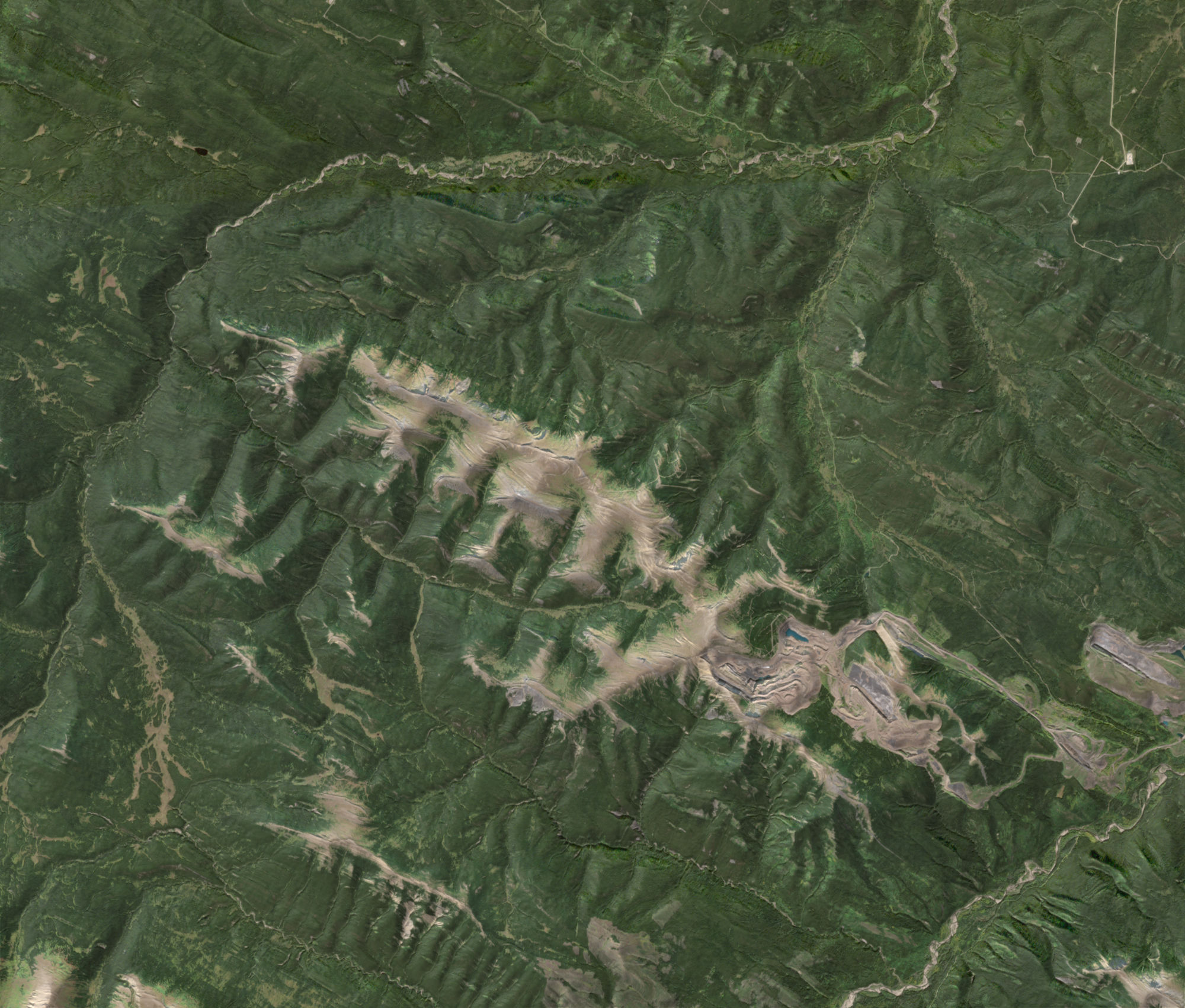 Caw Ridge from space: a pale alpine ridge running north-west above dark forest